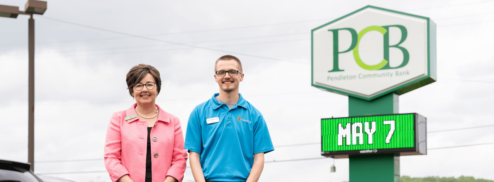 two people outside a PCB financial center